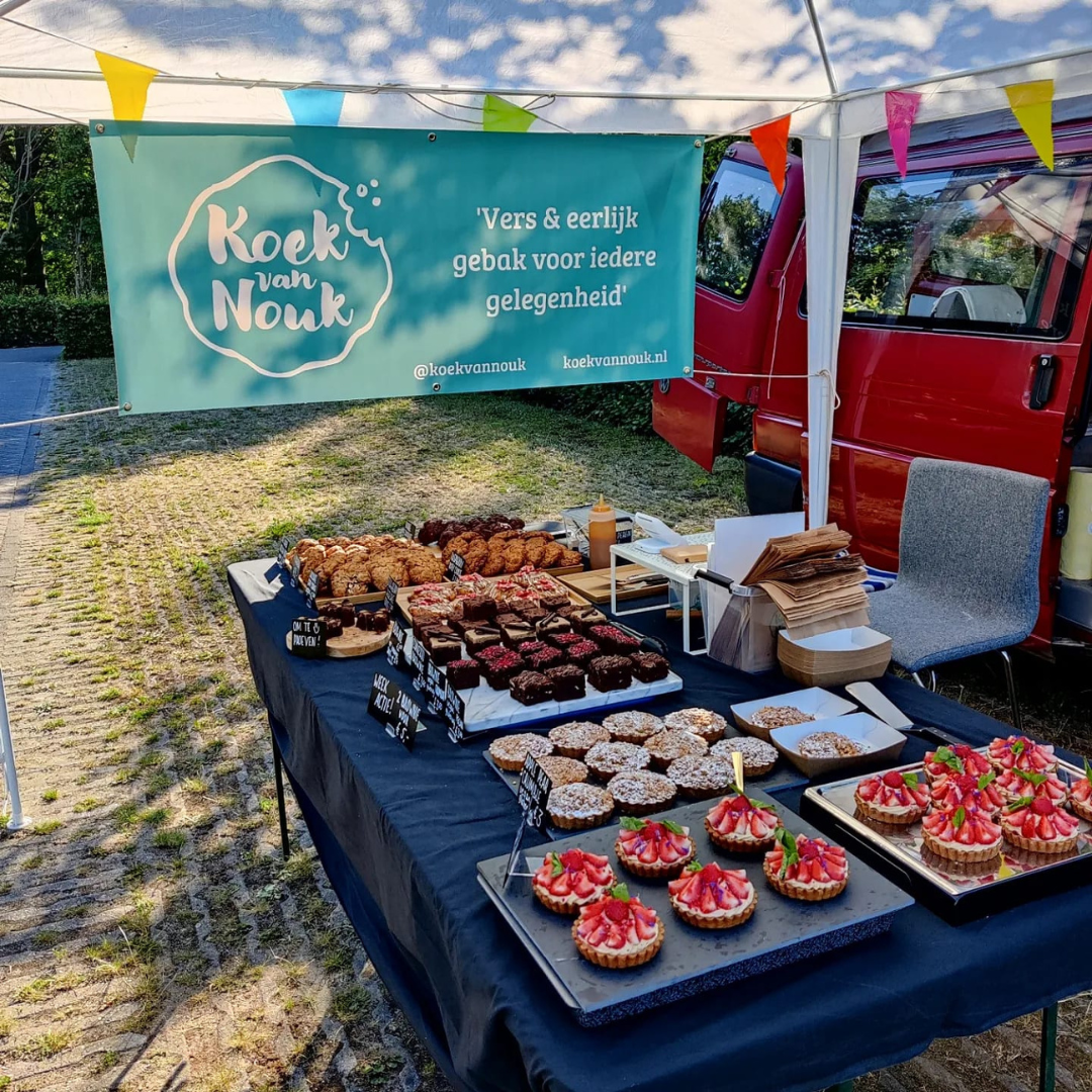 Tafel op de markt met brownies, koekjes, taarten en cupcakes voor feesten en bedrijven. Gemaakt door Koek van Nouk, een ambachtelijk, vegan-friendly bakhuis in Arnhem.